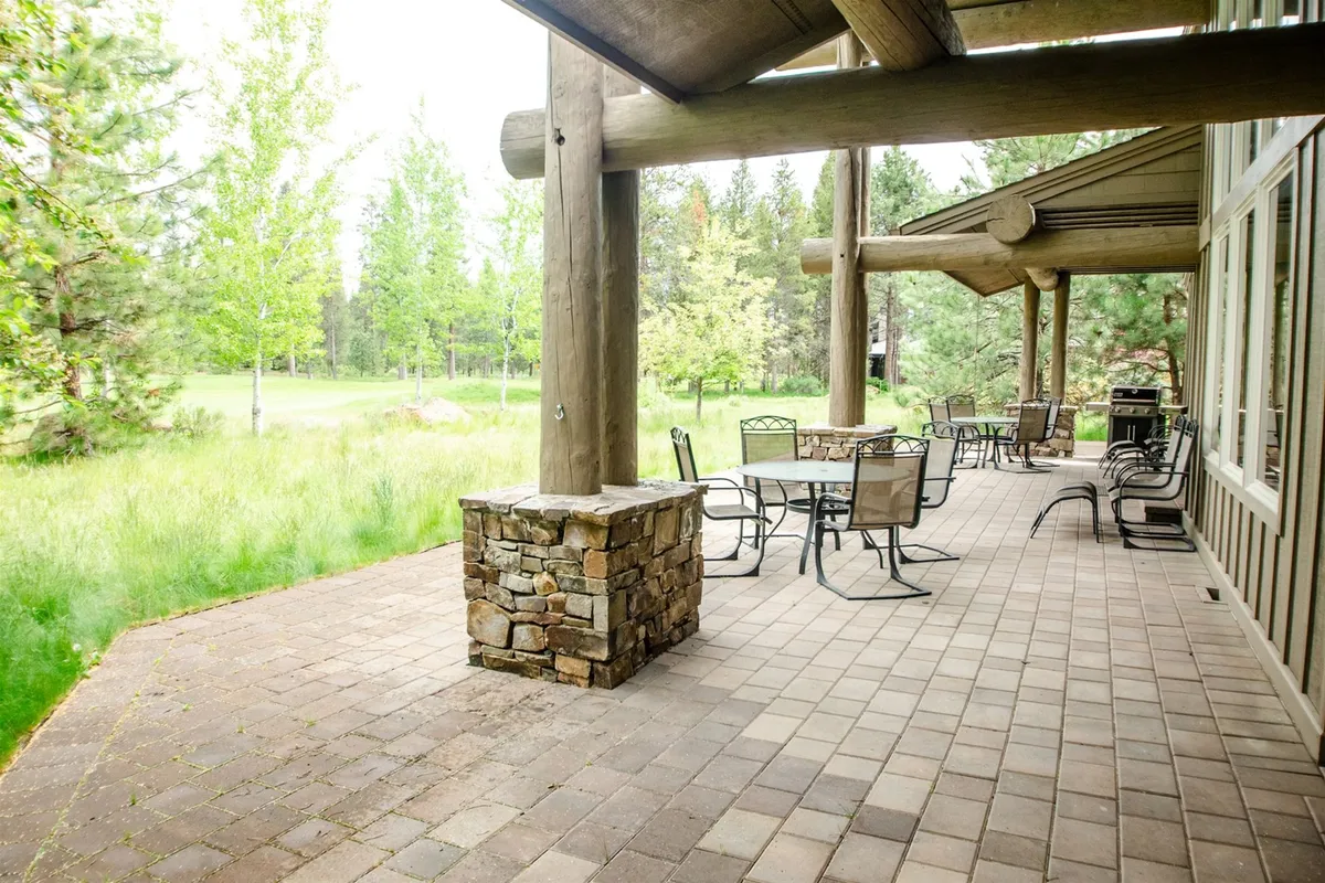 A cozy outdoor fire pit area surrounded by comfortable seating and lush greenery. The landscape invites guests to unwind under the open sky, ideal for sunset views or evening relaxation. The natural setting is perfect for quiet moments or lively conversations.